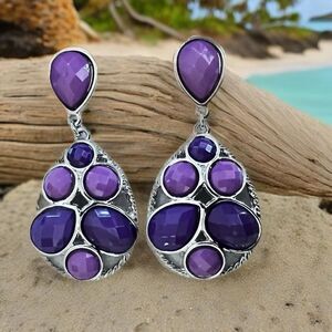 Earrings in shades of purple and silver on a post setting